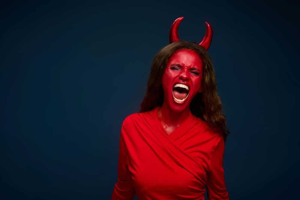 Woman in red devil suit