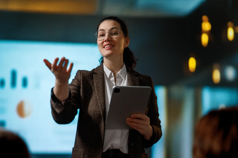 Woman communicating confidently in a professional workplace setting.