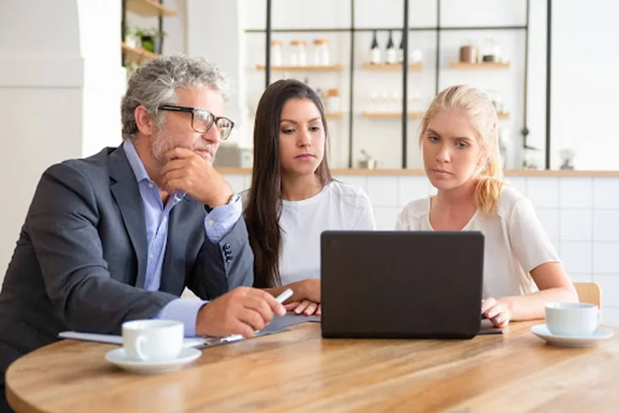 Business owners reviewing Santa Monica SEO services strategy on a laptop to improve local search ranking and Google Maps visibility.