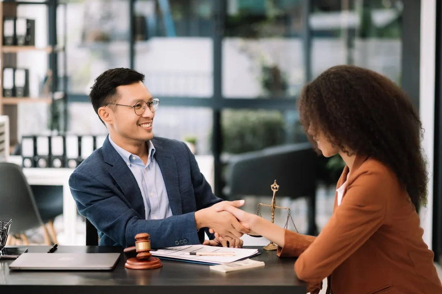 Attorney consulting with client in office.